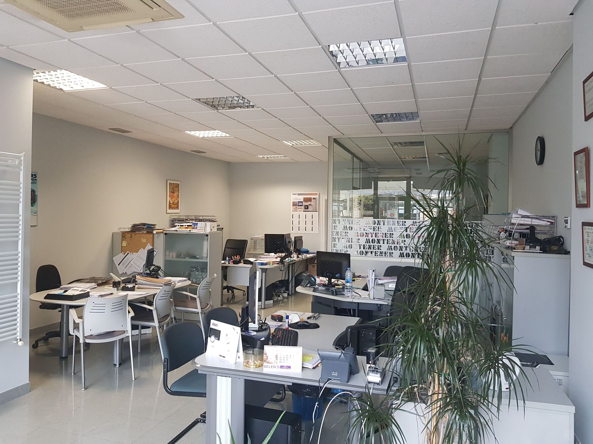 Una oficina grande con muchos escritorios y sillas.