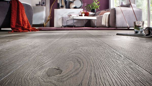 Ein Wohnzimmer mit Holzboden und Couch.