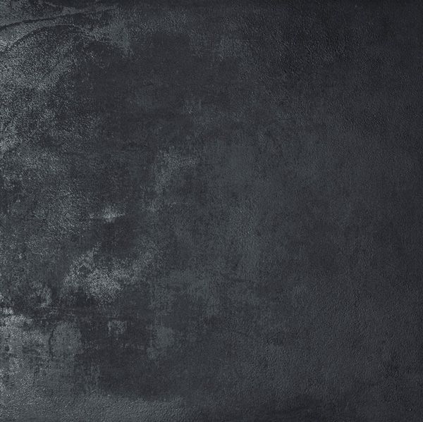 Eine Nahaufnahme einer schwarzen Fliese mit Grunge-Textur.