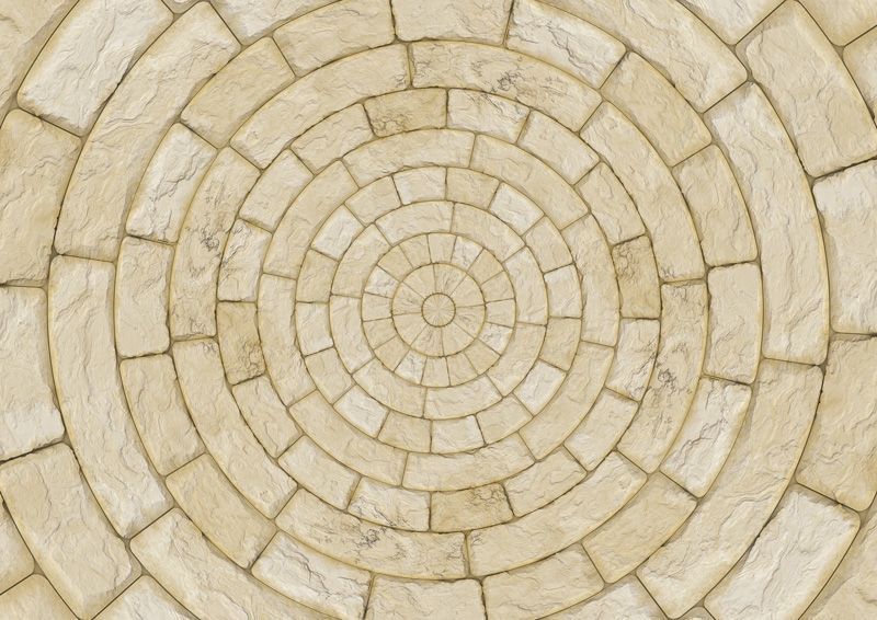 Eine Nahaufnahme eines kreisförmigen Ziegelmusters auf einem Boden.