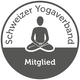 Circular logo: gray silhouette of a person in lotus position, 