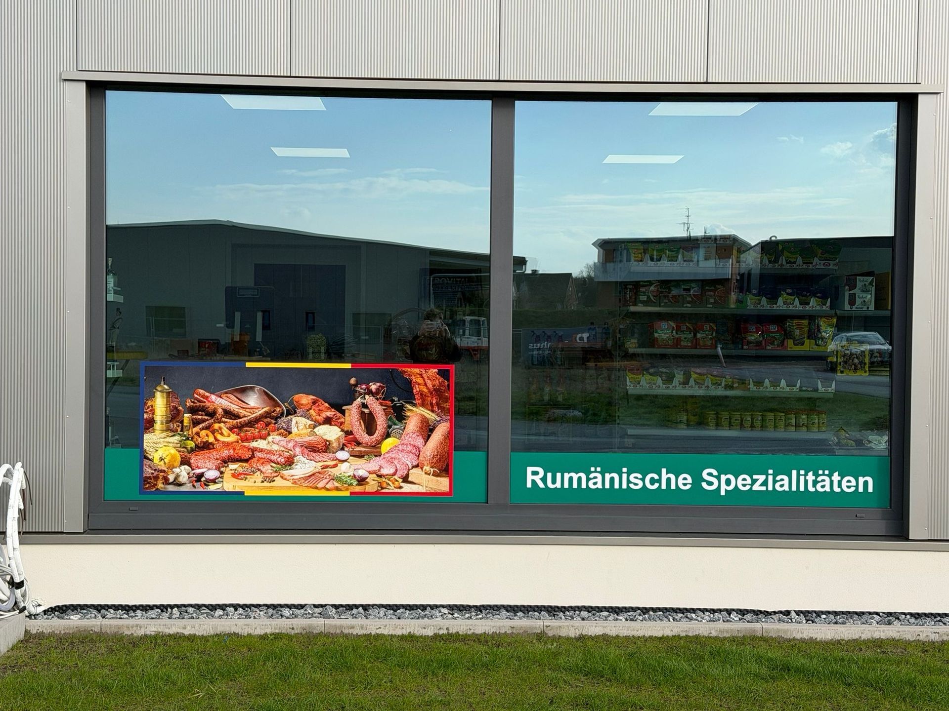 Storefront window with a meat display and the sign “Rumänische Spezialitäten”