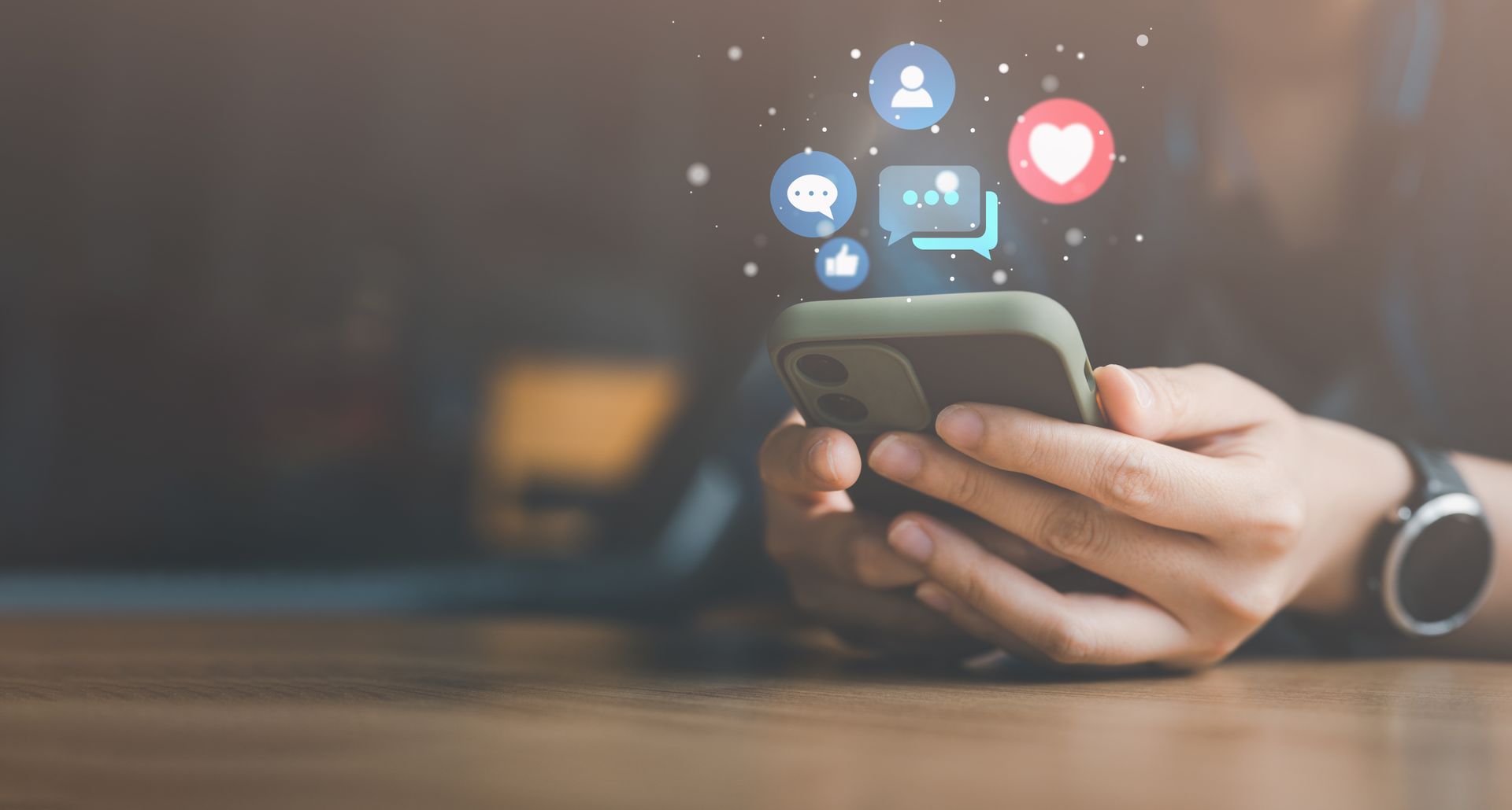 Hände, die ein Smartphone halten, über dem Benachrichtigungssymbole sozialer Medien schweben.