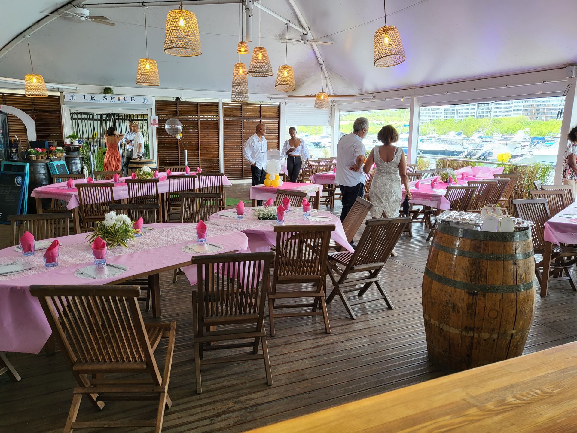 Tables avec nappes roses pour événements avec vue terrasse.