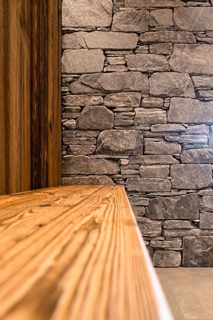 vue d'un mu en pierre avec un banc en bois devant