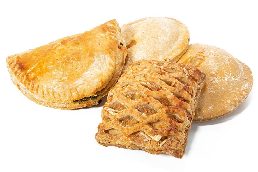 Tres pasteles están uno al lado del otro sobre una superficie blanca.