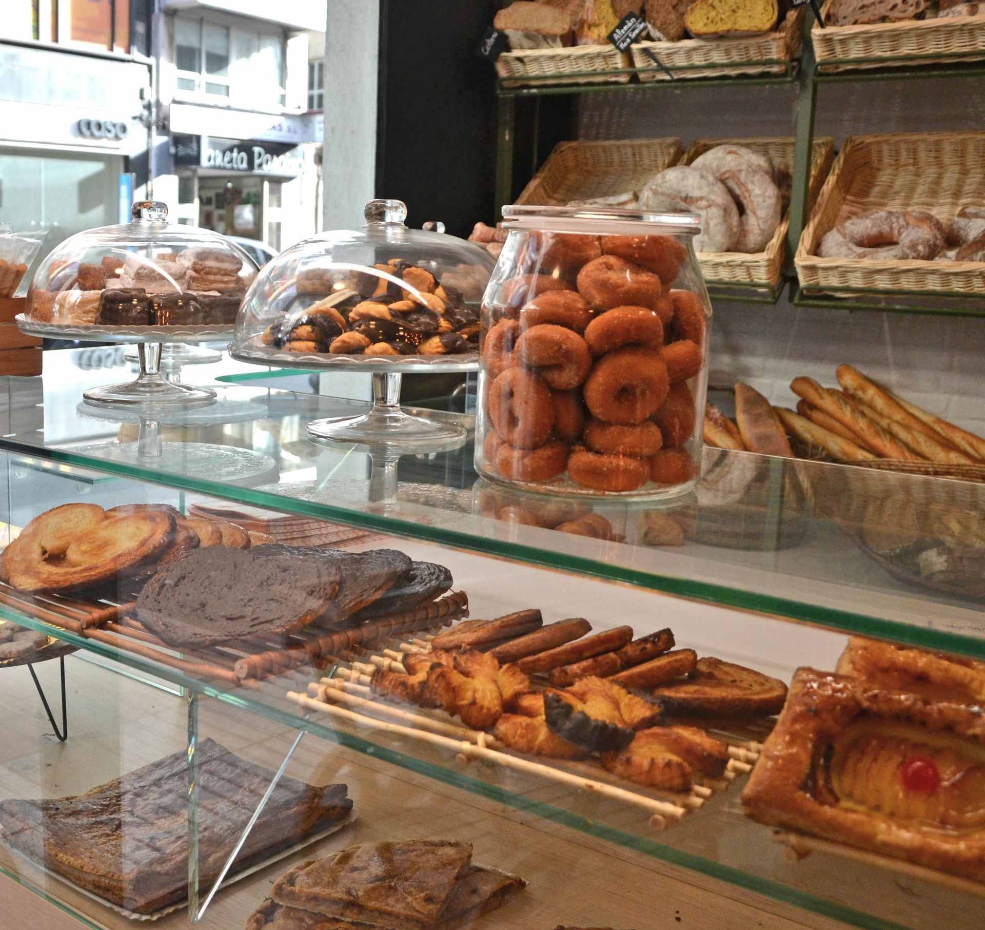 Una vitrina de cristal llena de una variedad de pasteles.