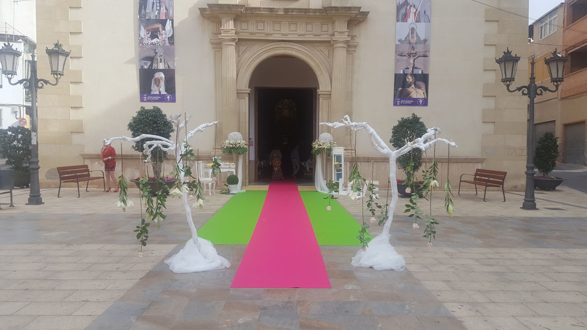 Una iglesia con una alfombra roja y verde delante de ella.