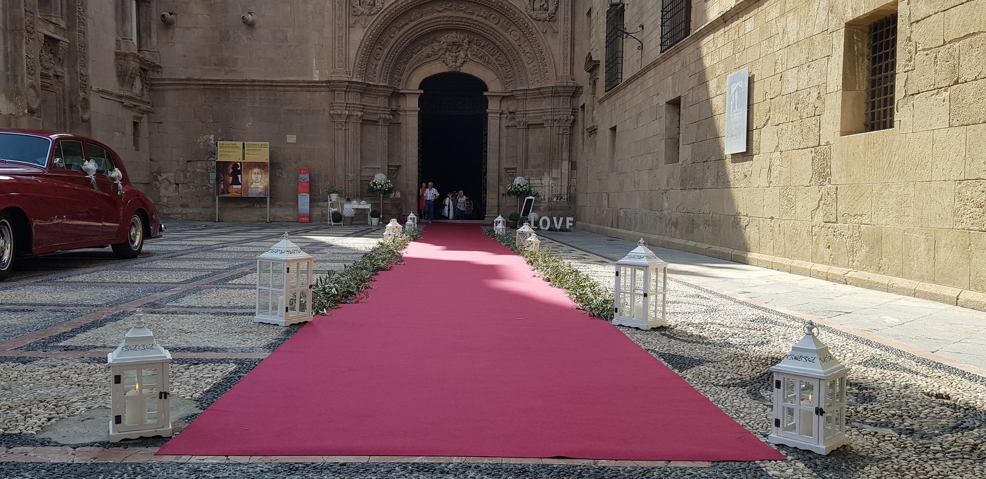 Una alfombra roja está colocada delante de una iglesia.