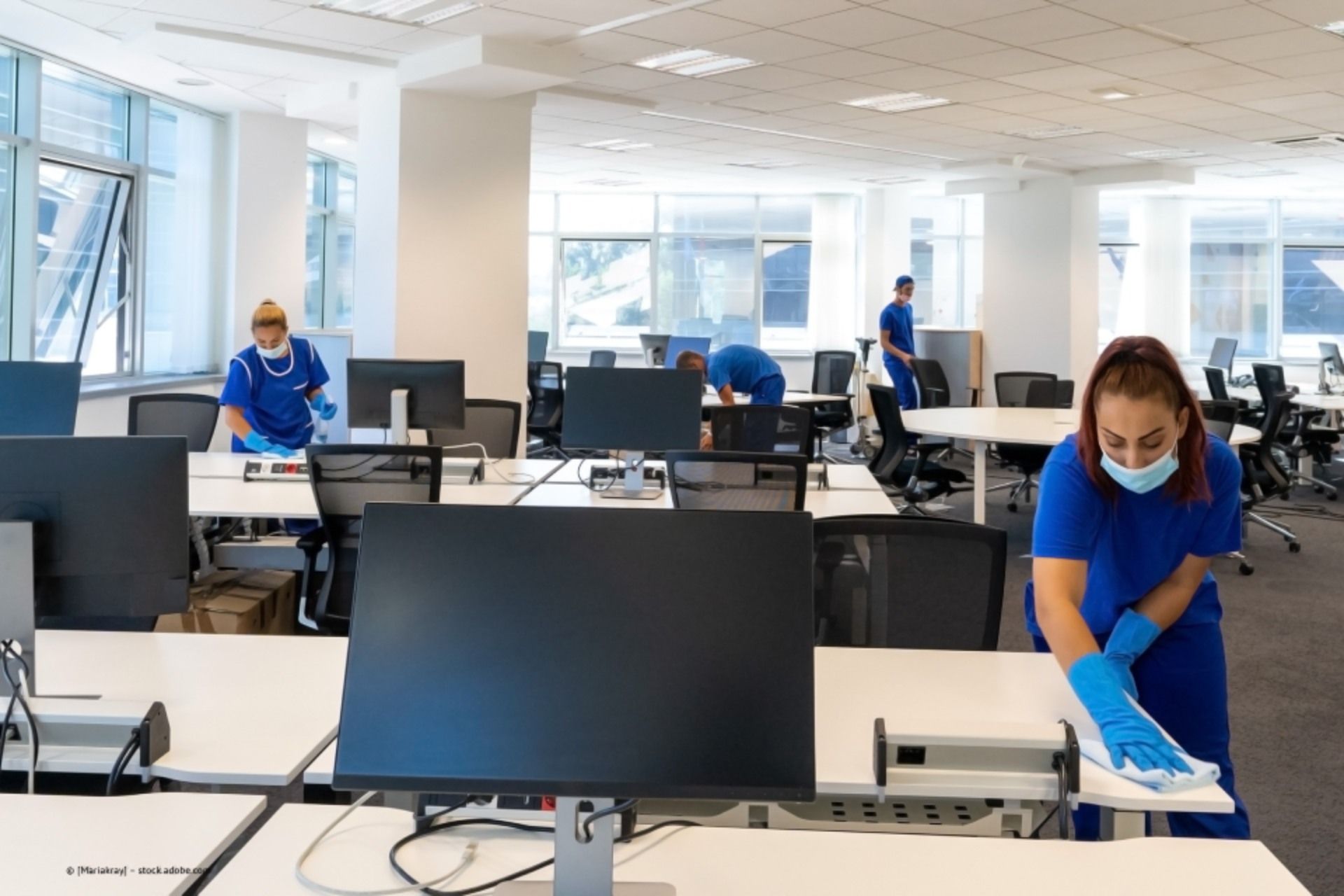 Multiline GmbH - Drei Reinigungsfachkräfte bei der Reinigung von Fenstern, Böden und Möbeln in einem Büro