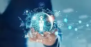 Personas revisando documentos en una mesa. Se ven gráficos y papeles, una chaqueta naranja y una computadora portátil.