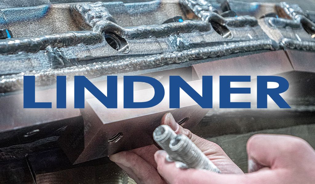 Eine Hand mit einem Werkzeug bearbeitet Metallteile, über dem Bild ist der Name „LINDNER“ eingeblendet.
