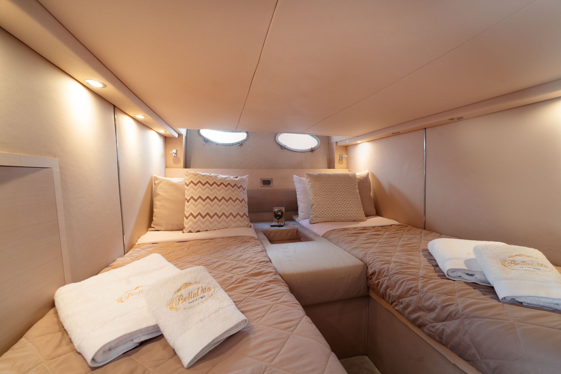 Cozy tent-like sleeping nook with two beds, pillows, and blankets under warm lighting