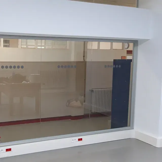 Un rincón de una habitación con una gran ventana de cristal.