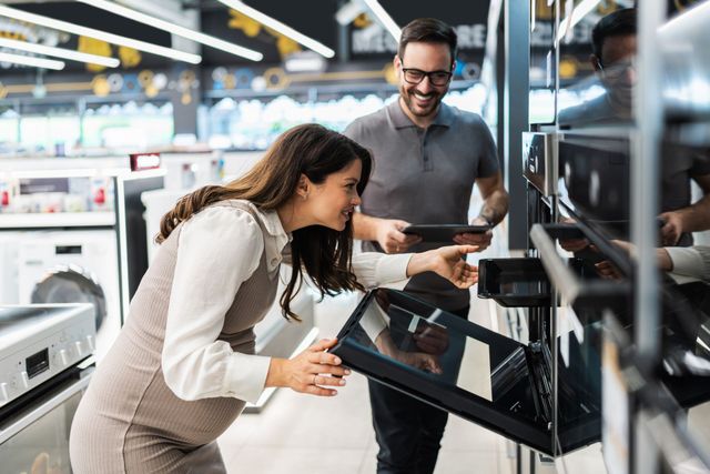Gros plan sur une plaque de cuisson à gaz en acier inoxydable avec quatre brûleurs, grilles noires et boutons de commande.