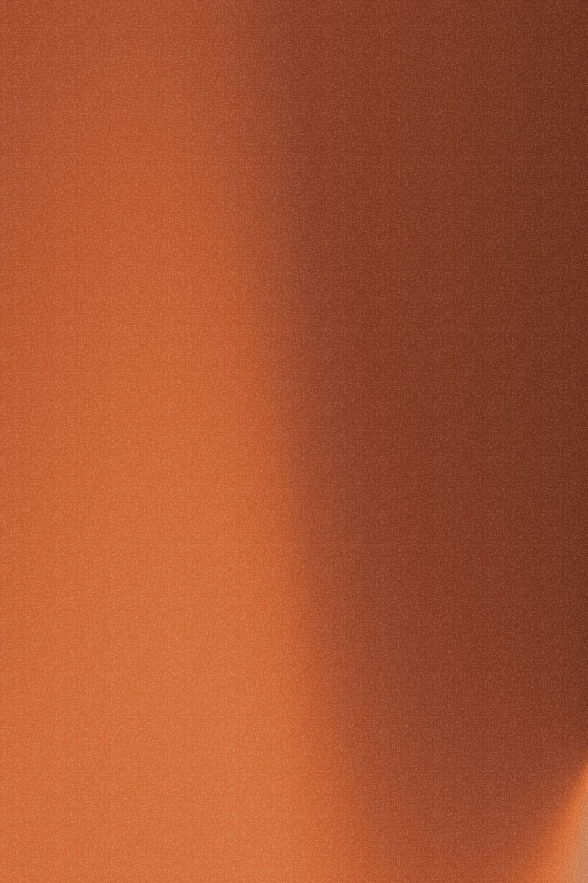 Fond texturé orange et marron avec une lumière douce venant de la gauche.