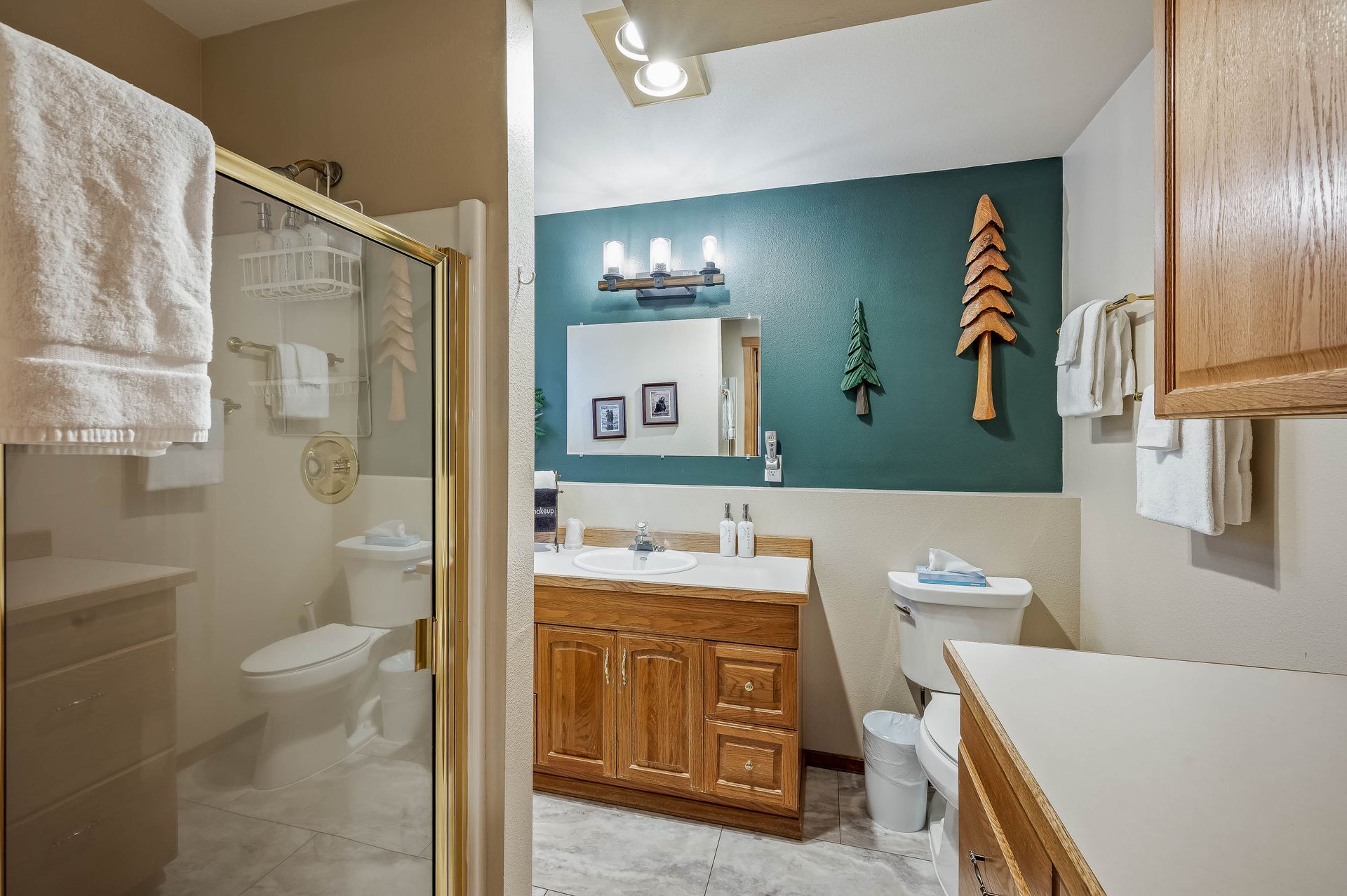 A bathroom with a toilet , sink , and shower.