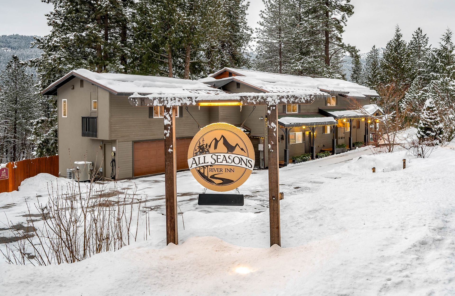 A house with a sign in front of it that says all seasons