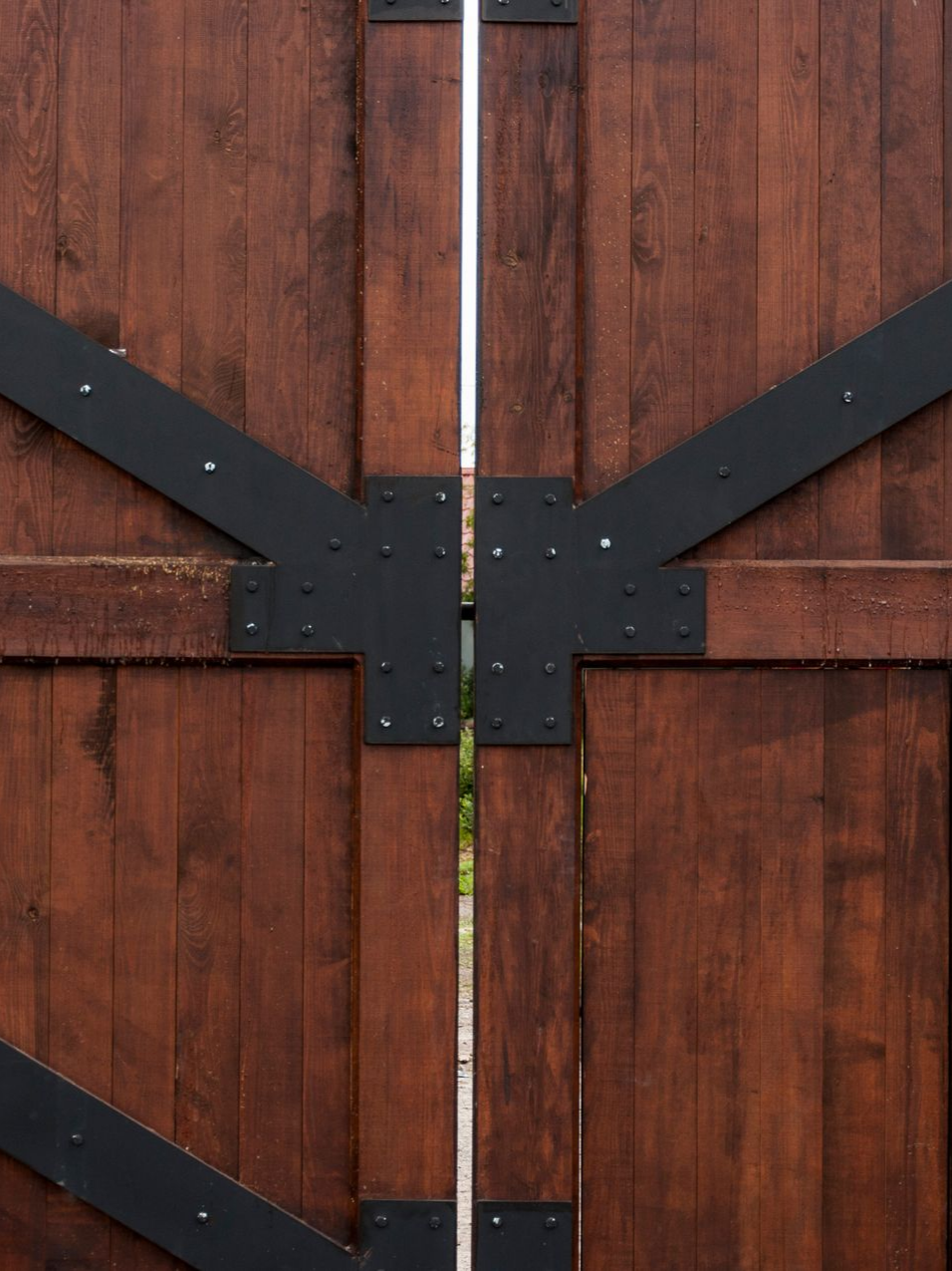 Le verrou d'un portail battant en bois et fer