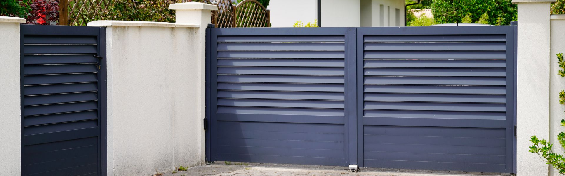 Un portail battant en aluminium gris