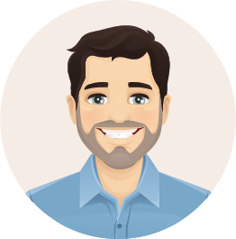 Ein Mann mit Bart lächelt und trägt ein blaues Hemd.