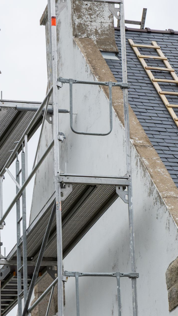 Des échaffaudages contre le mur d'une maison.
