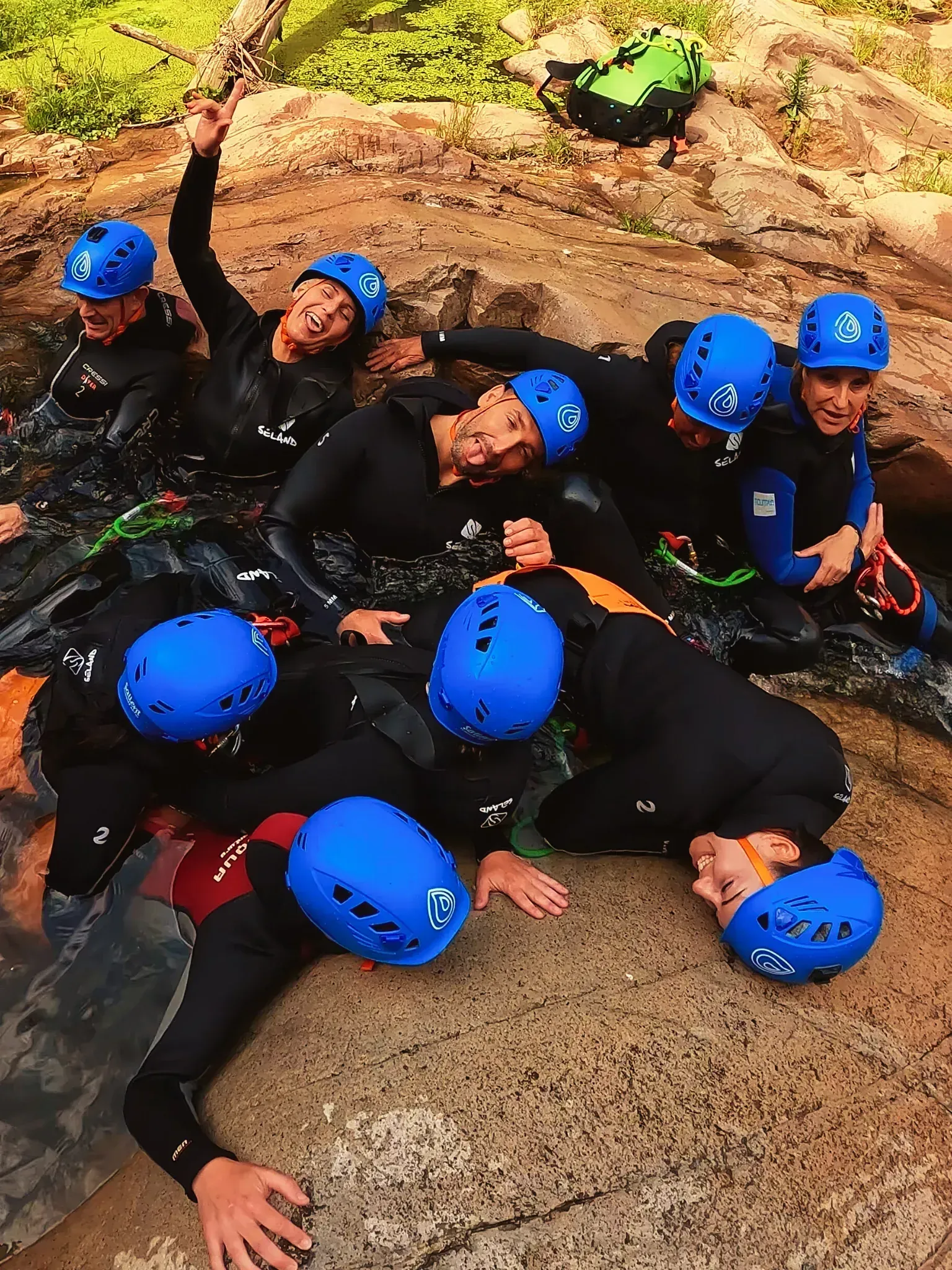 Un grupo de personas que llevan cascos azules yacen en el suelo.
