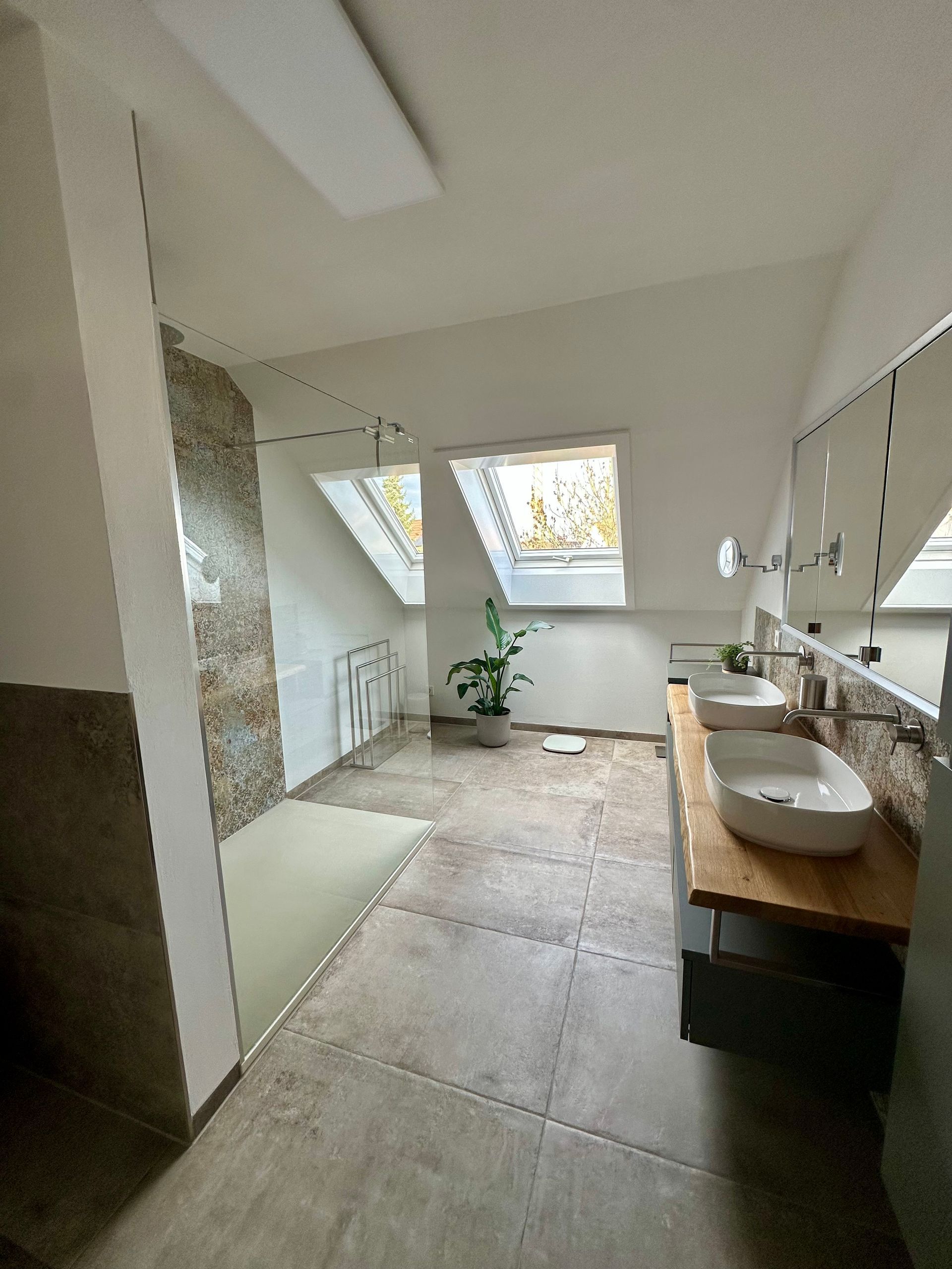 Modernes Badezimmer mit Oberlicht, großem Spiegel, Waschtisch aus Holz und begehbarer Dusche