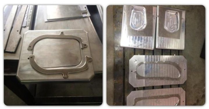 Uma máquina está cortando um pedaço de metal em uma mesa.