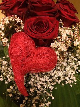 Blumengesteck mit dunklen Roten Rosen, Schleierkraut und einem Herz