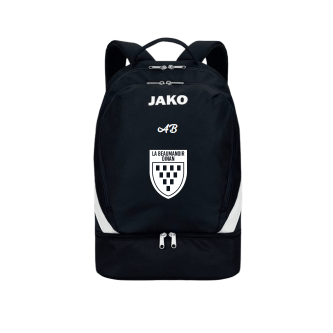 Sac à dos JAKO noir avec logo blanc, écusson et poche zippée inférieure sur fond blanc.