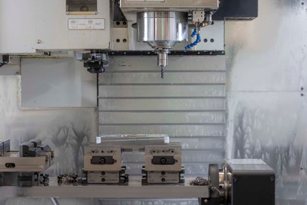 In einer Fabrik schneidet eine Maschine ein Stück Metall.