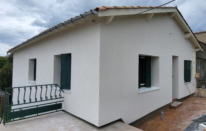 ITE à Castelnaudary d'une maison avec des volets verts