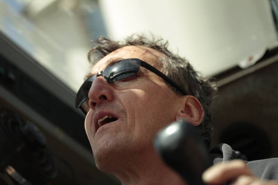 Ein Mann mit Sonnenbrille telefoniert mit einem Mobiltelefon