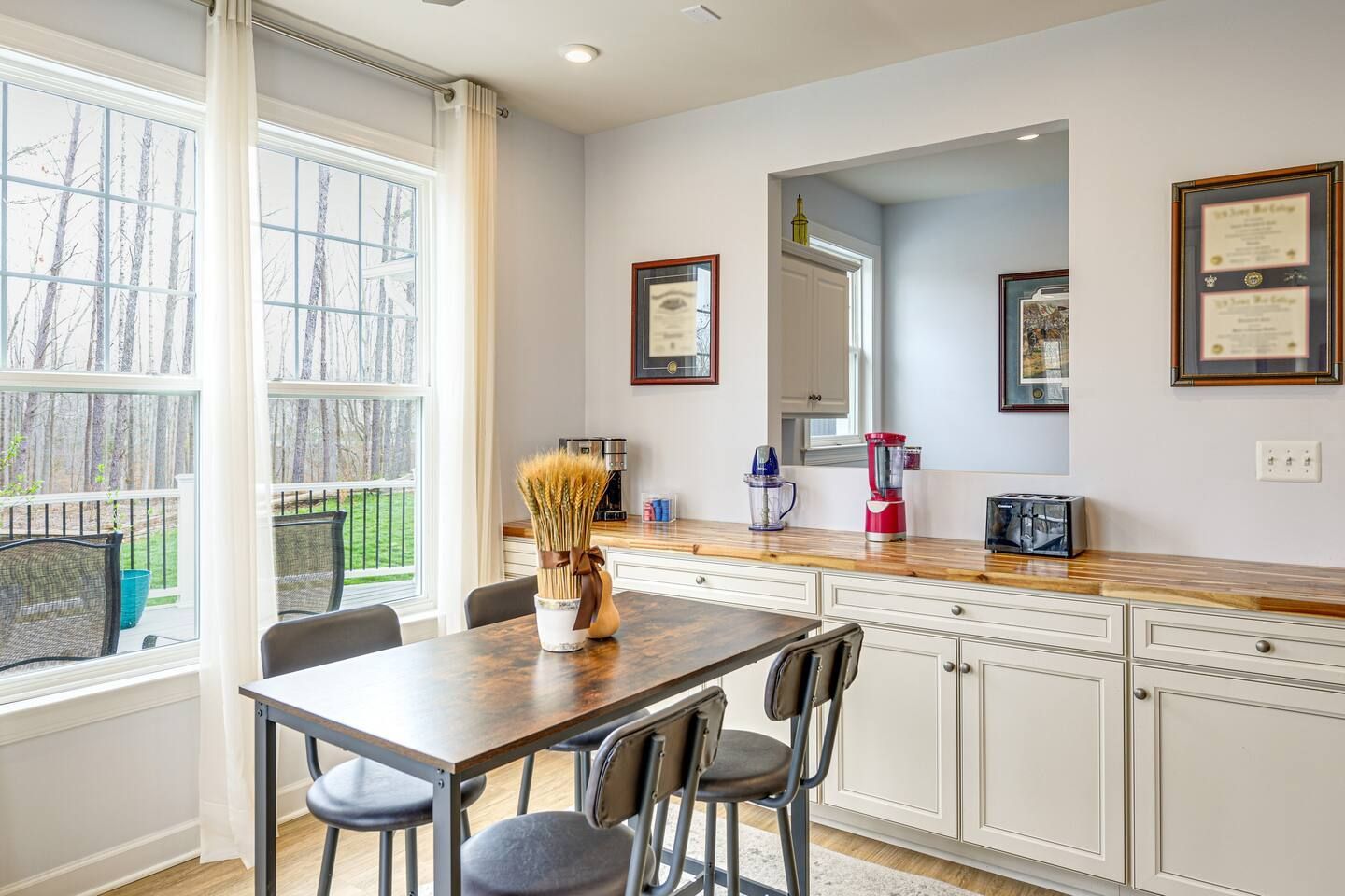 A kitchen with a table and chairs and a window.