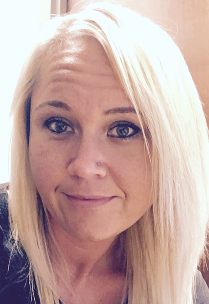 A close up of a woman 's face with blonde hair.