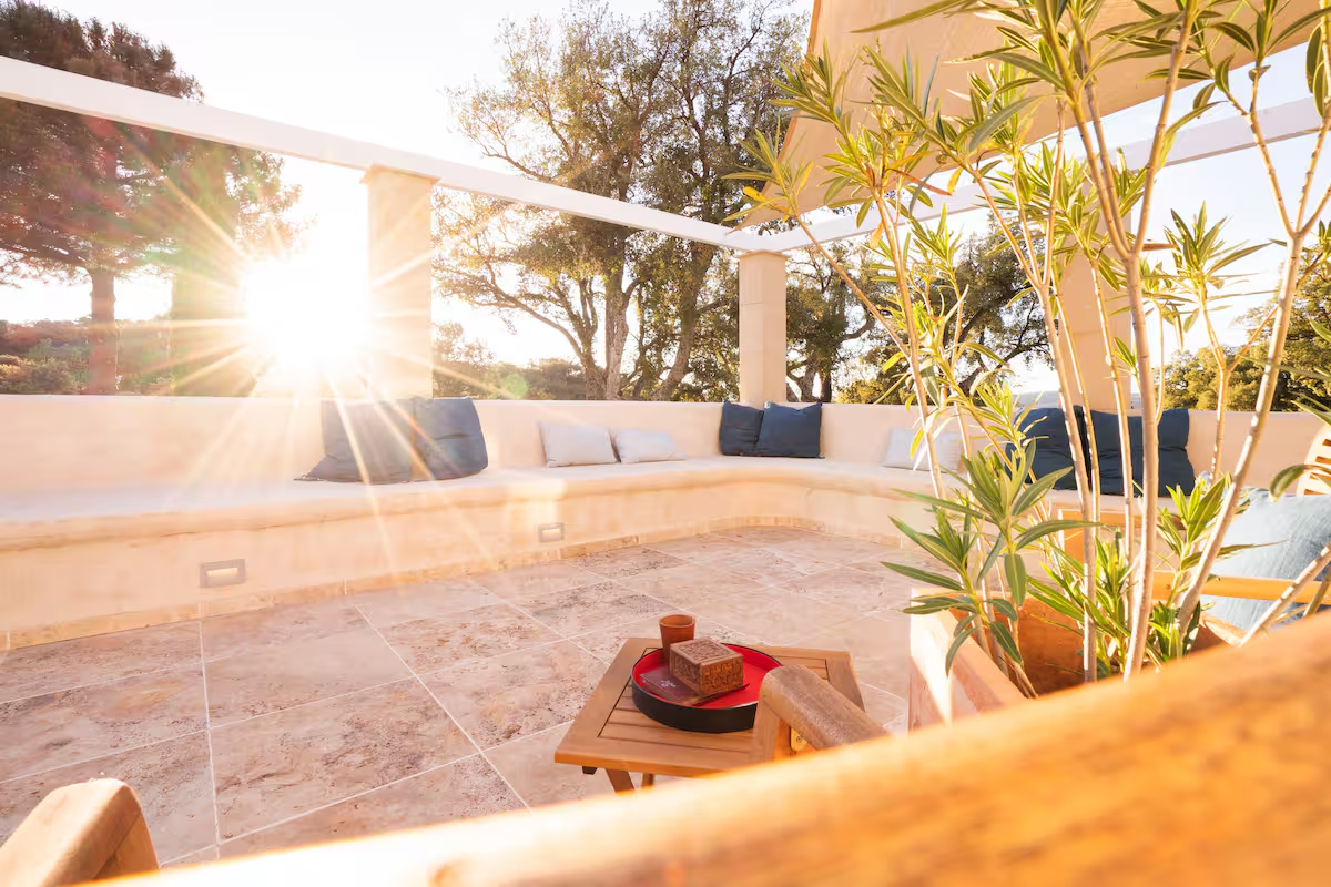 Built-in outdoor seating area with cushions in the evening sun
