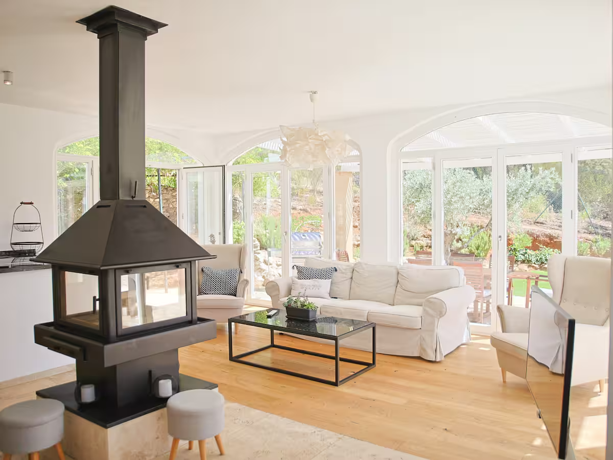 Bright living area with modern fireplace and arched garden windows