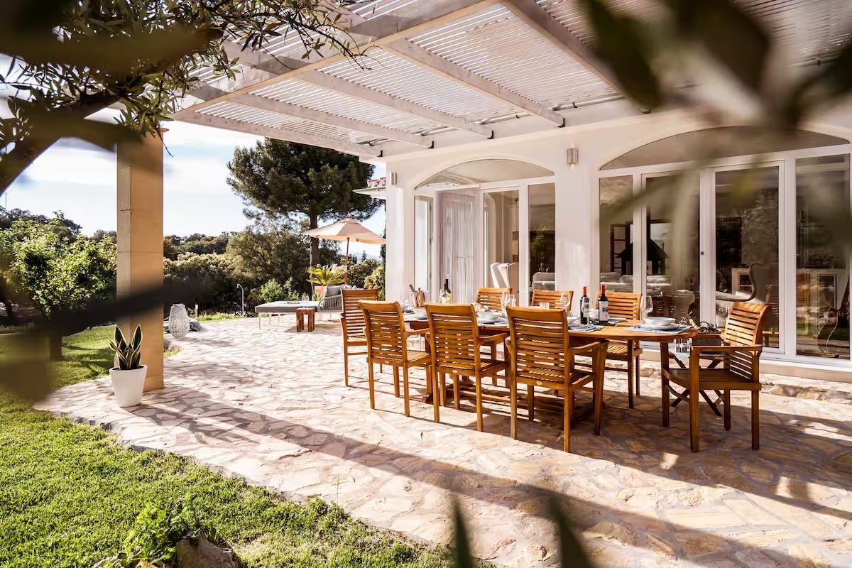 Large dining table for up to 10 guests on the sunny terrace