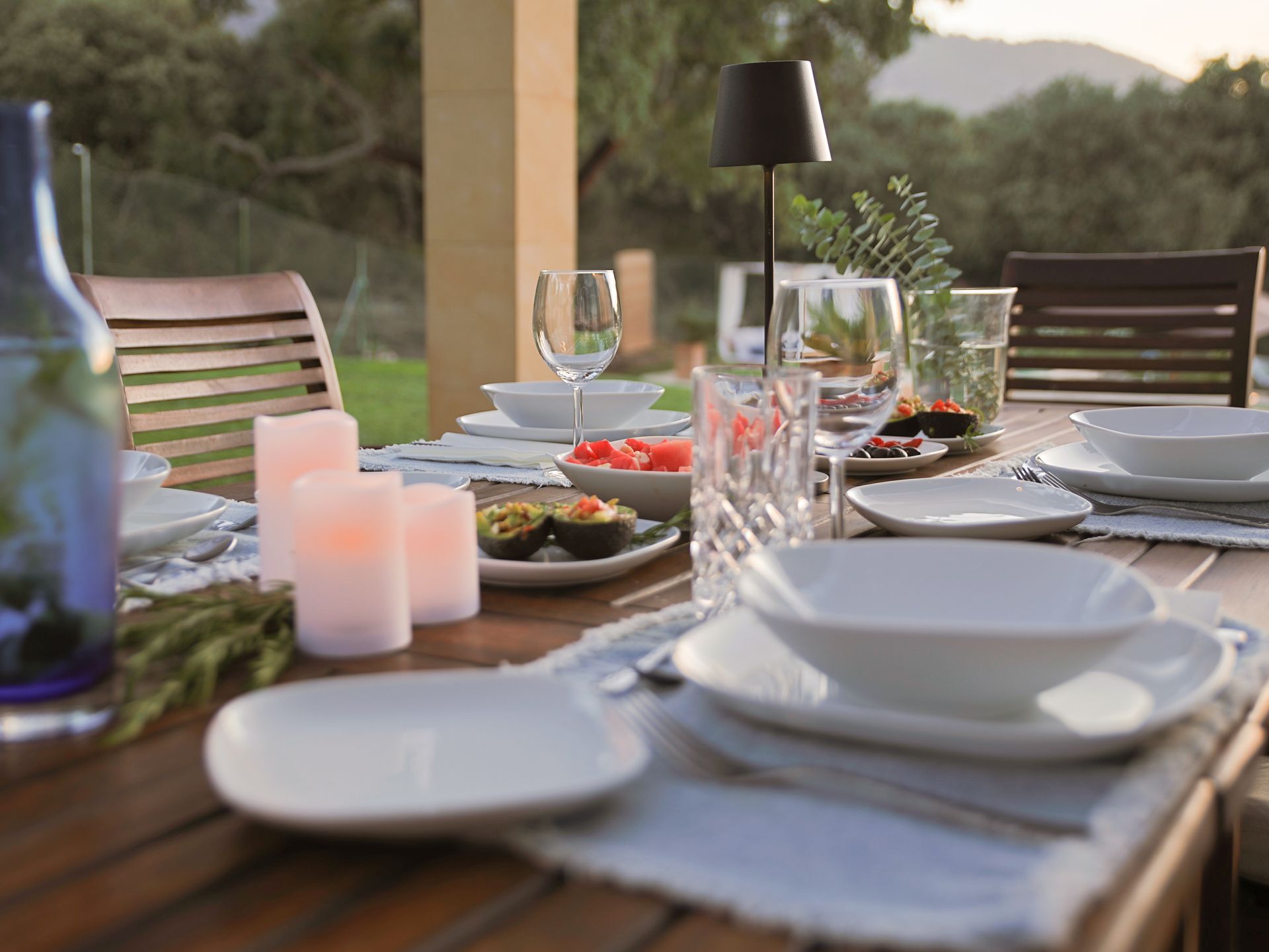 Candlelit dinner table on the terrace with mountain views at dusk