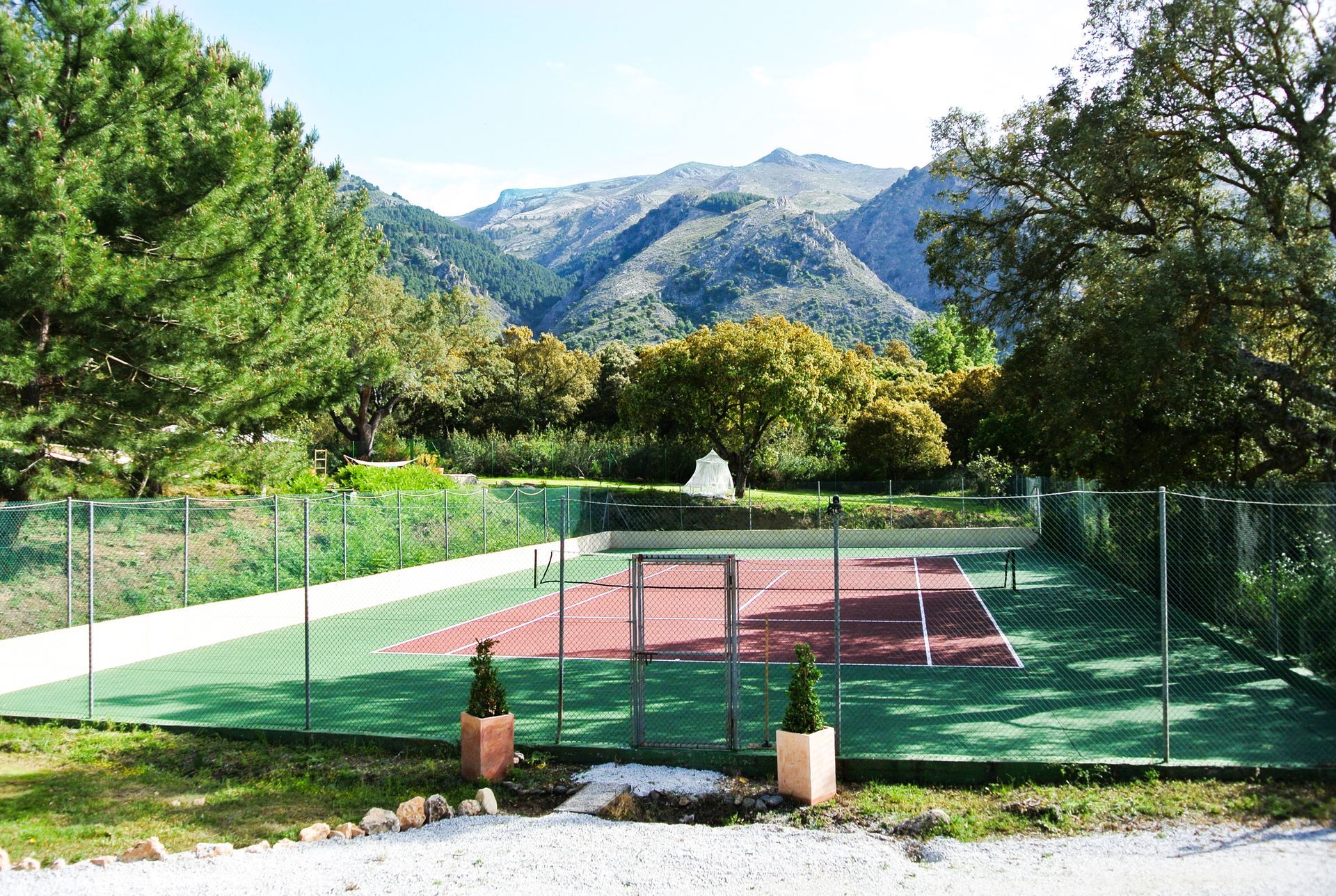 Private hard court tennis court with mountain views
