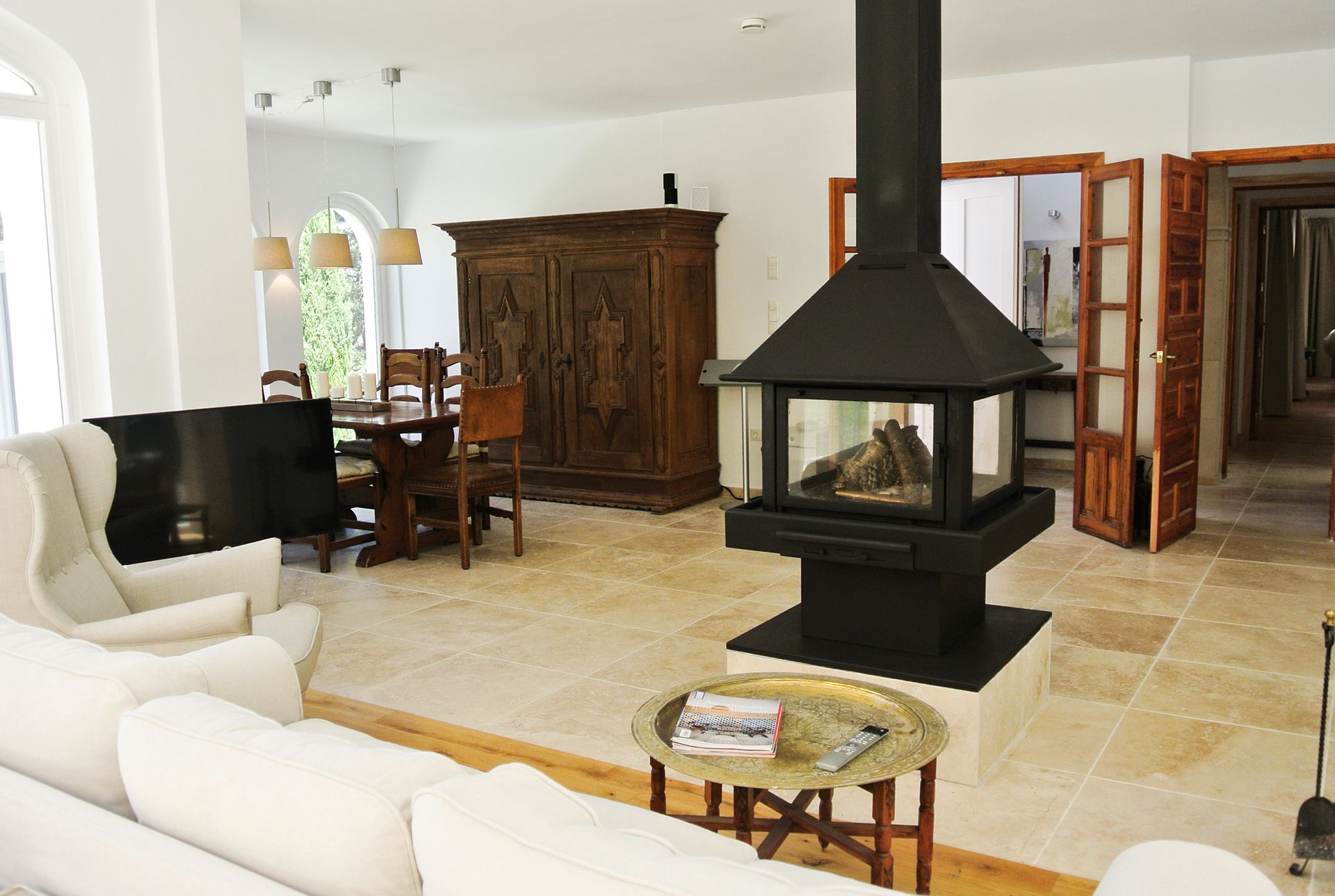 Living room with fireplace, antique wooden cabinet and dining area