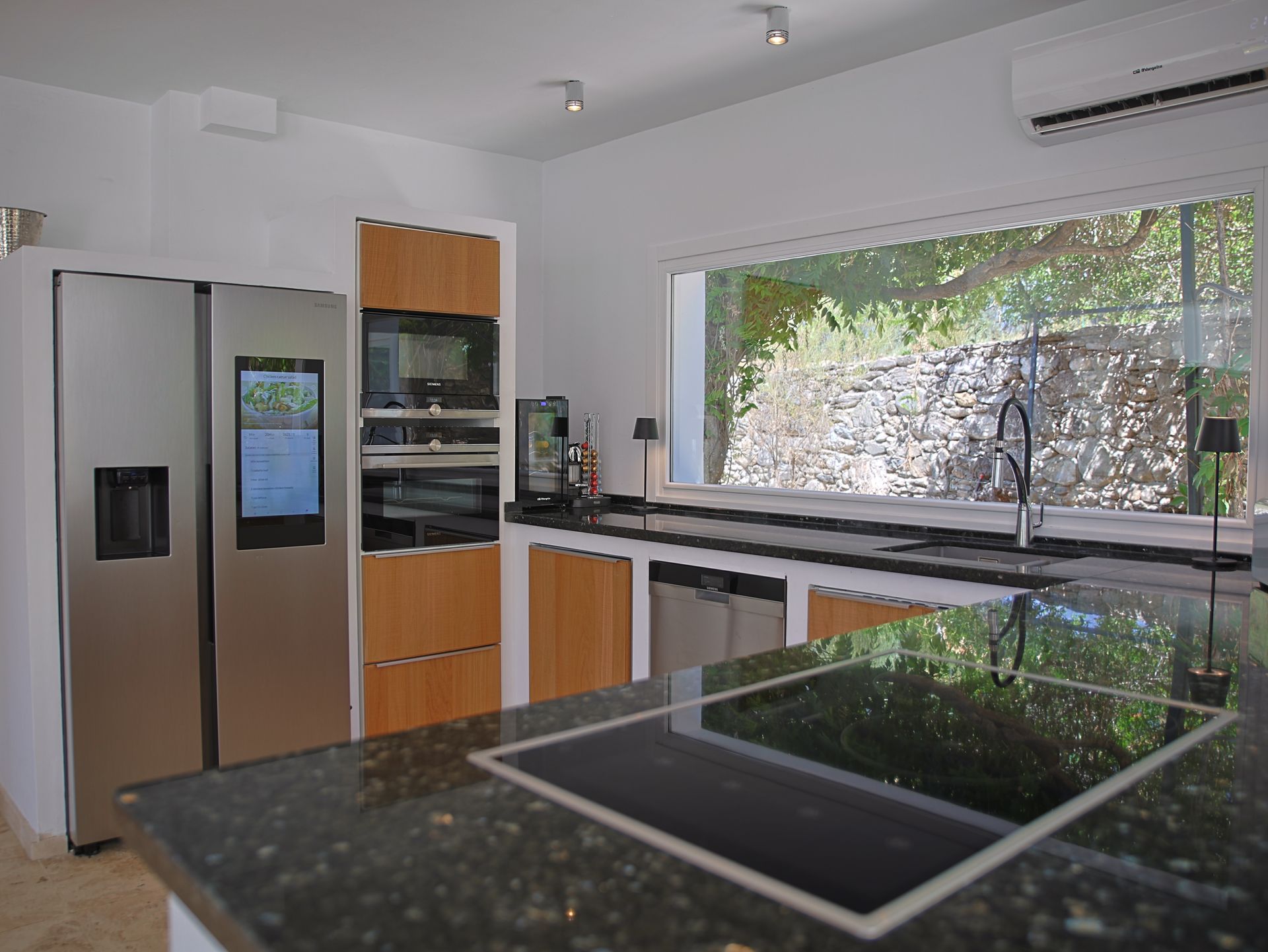 Modern kitchen with Samsung side-by-side fridge and Siemens appliances