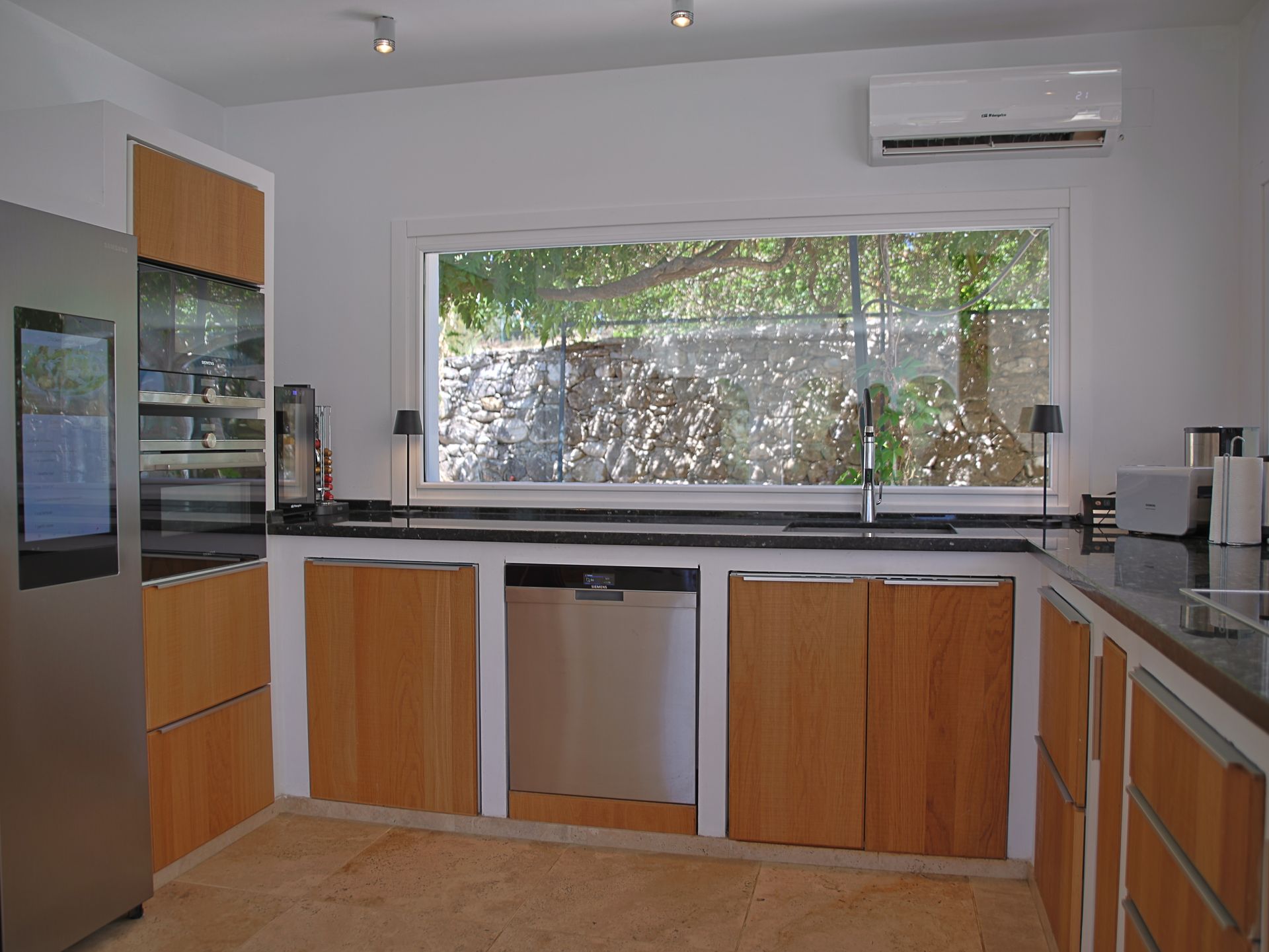 Fully equipped kitchen with large panoramic window to the garden