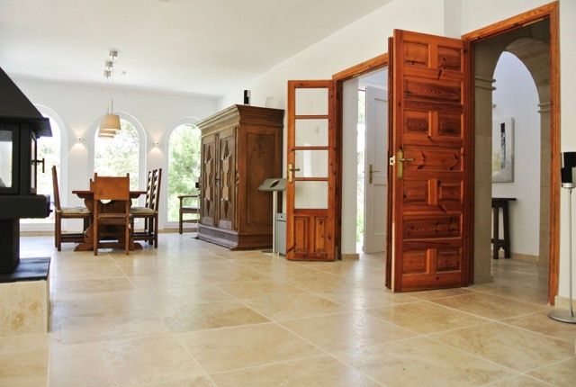 Bright hallway with carved wooden doors leading to the dining area