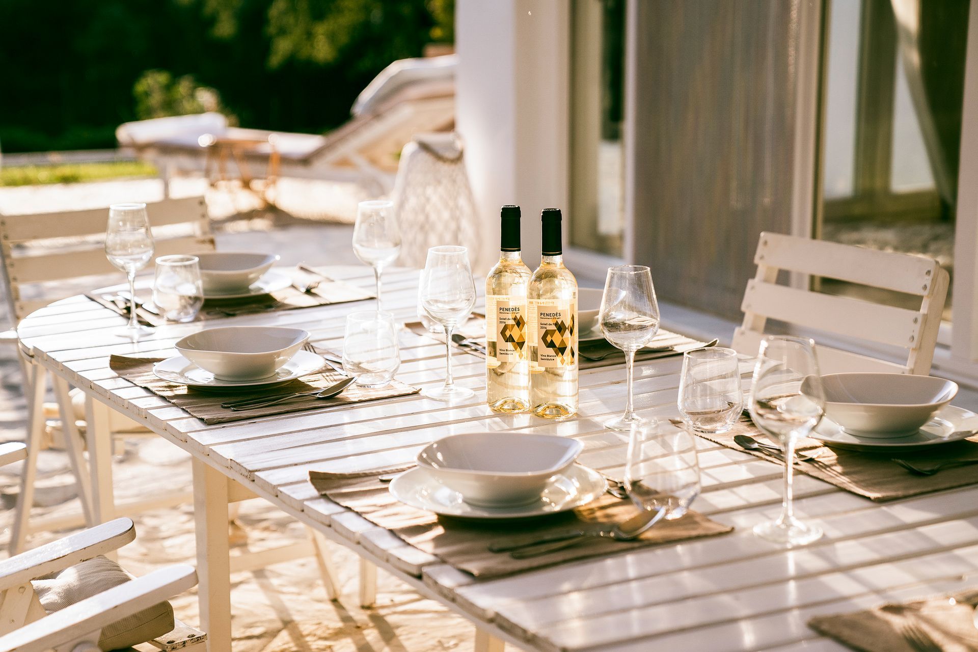 Table set with wine glasses for dinner on the terrace