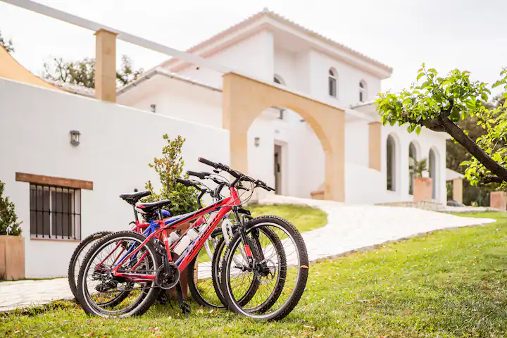 Mountain bikes in front of the white Andalusian villa
