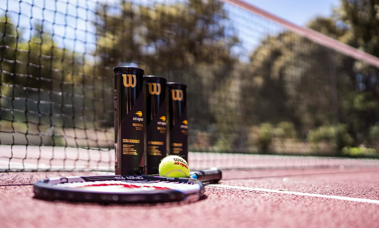 Tennis racket and balls on the private tennis court