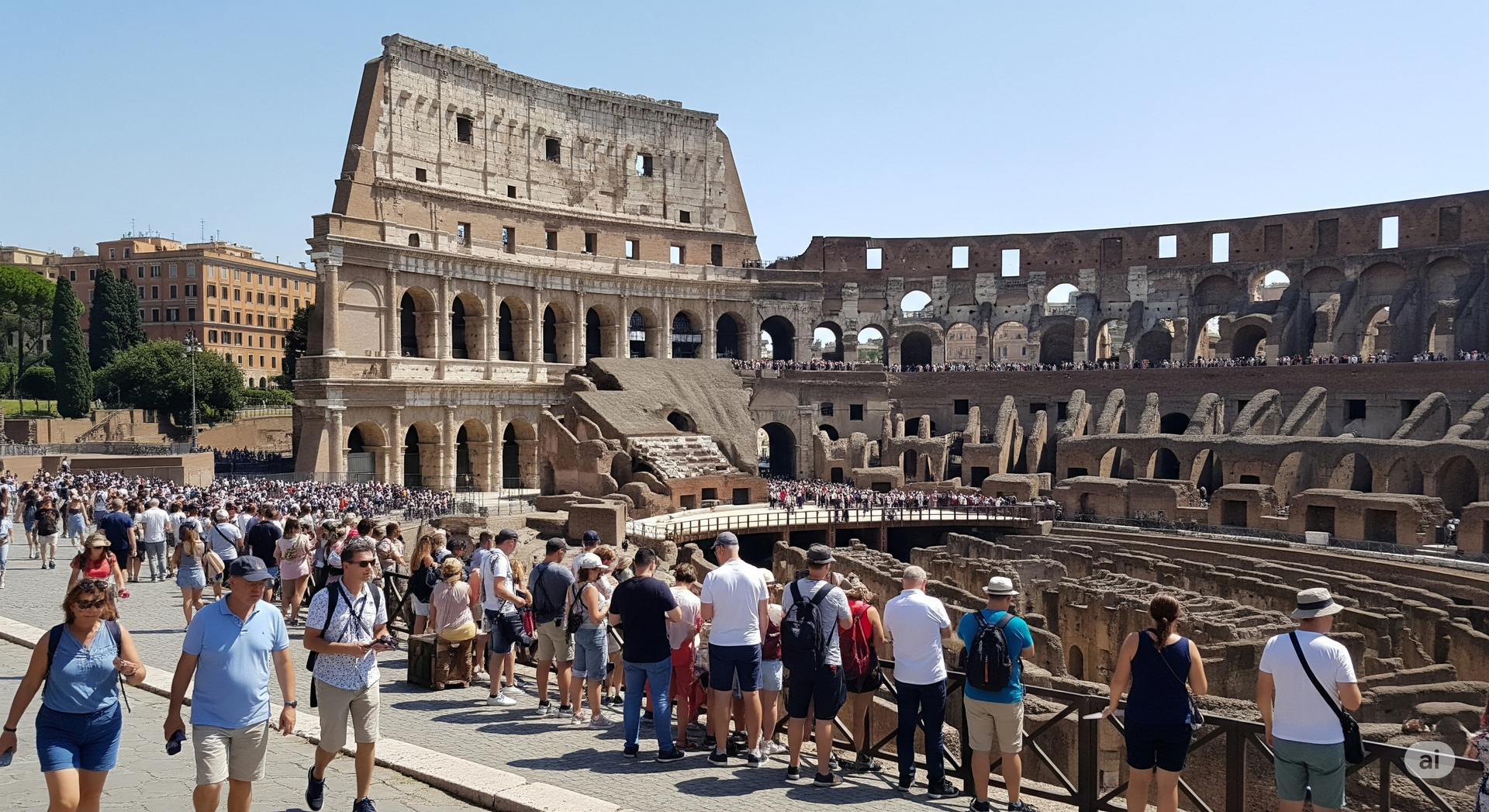 Colosseum in Rome filled with tourists on a sunny day.