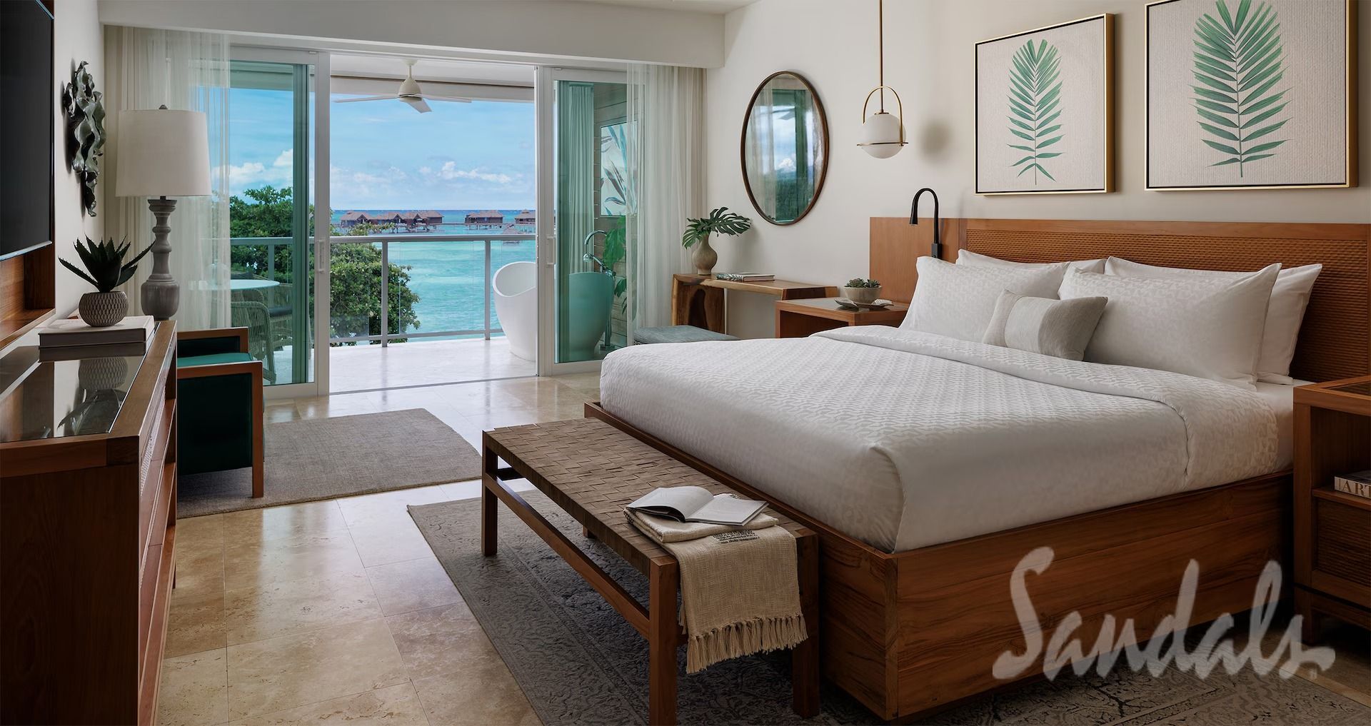 Luxury bedroom with ocean view at Sandals resort.
